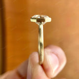 Side view of Moissanite octagon step cut bezel set cathedral style solitaire ring showing the high polish finish.