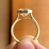 Close-up view of the cathedral setting showcasing the Moissanite octagon step cut in 10K yellow gold.