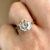 Moissanite octagon step cut bezel set cathedral style solitaire ring worn on the hand, highlighting the elegant design