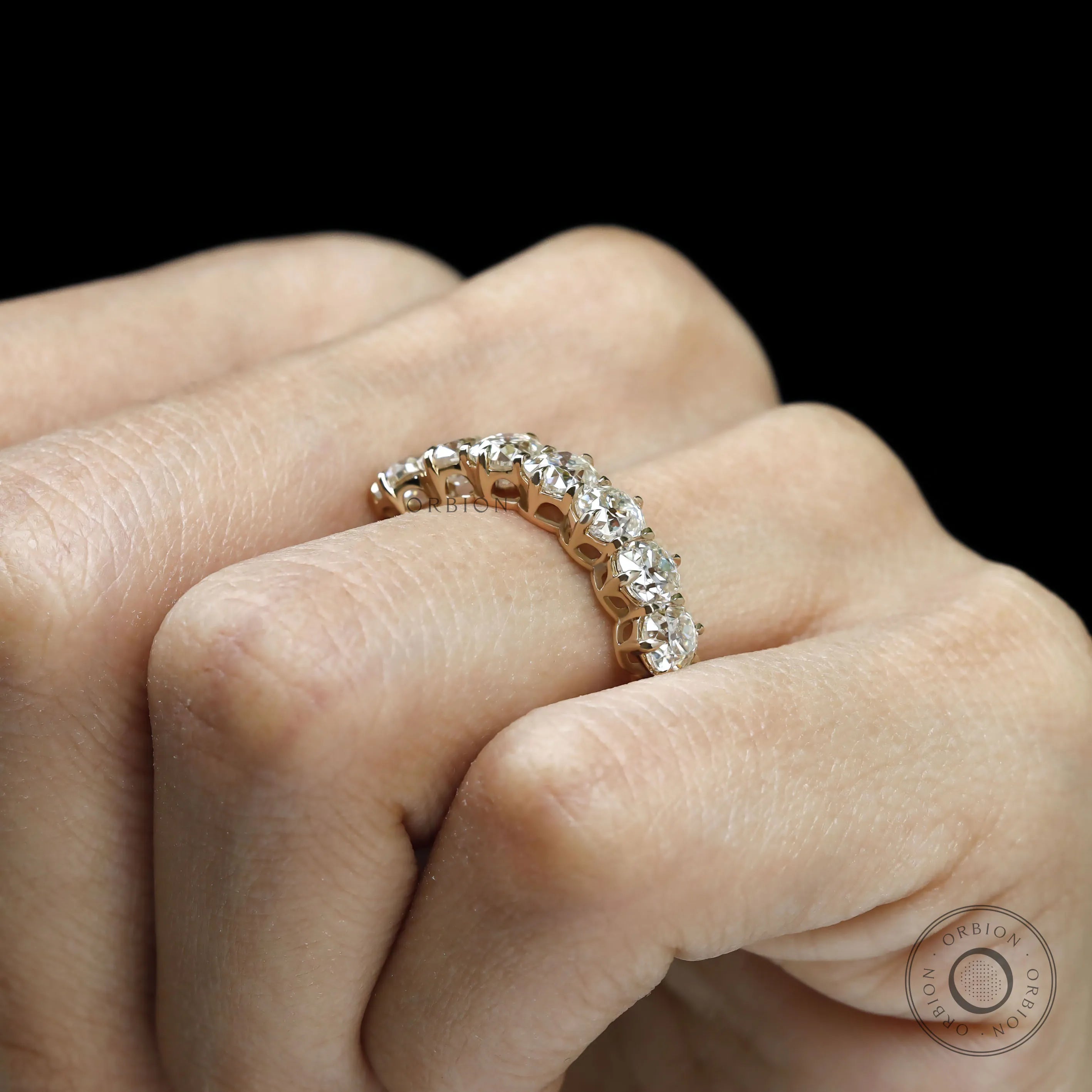 Old mine cut seven stone cushion moissanite wedding band in yellow gold, half eternity design