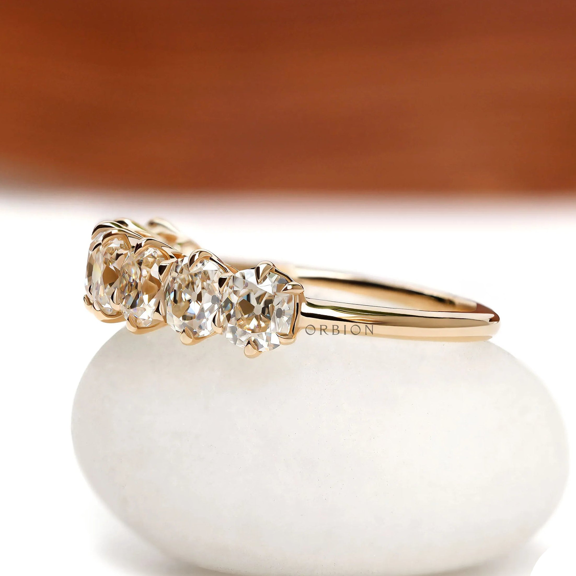 Classic seven stone cushion moissanite wedding band in yellow gold, old mine cut, half eternity setting