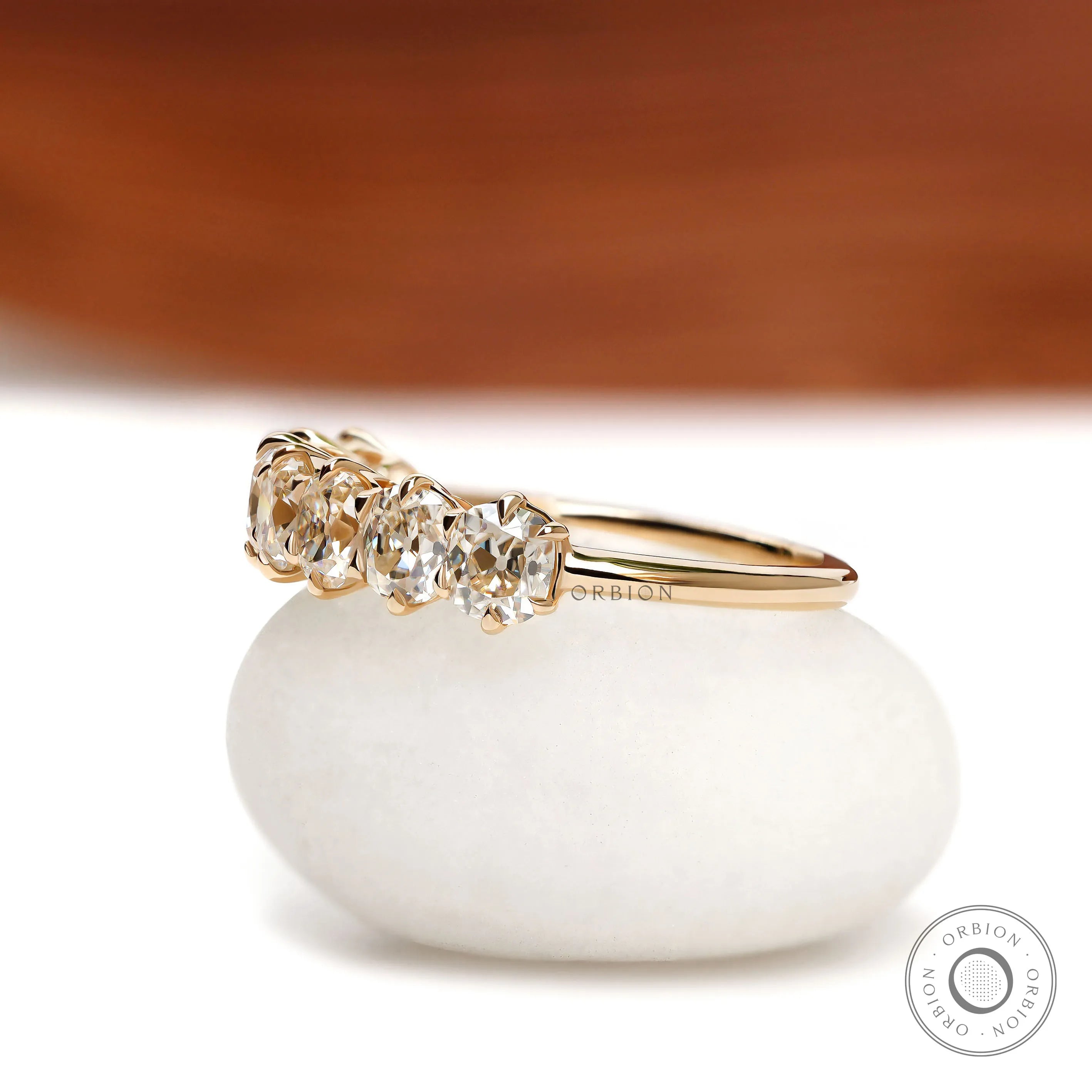 Classic seven stone cushion moissanite wedding band in yellow gold, old mine cut, half eternity setting