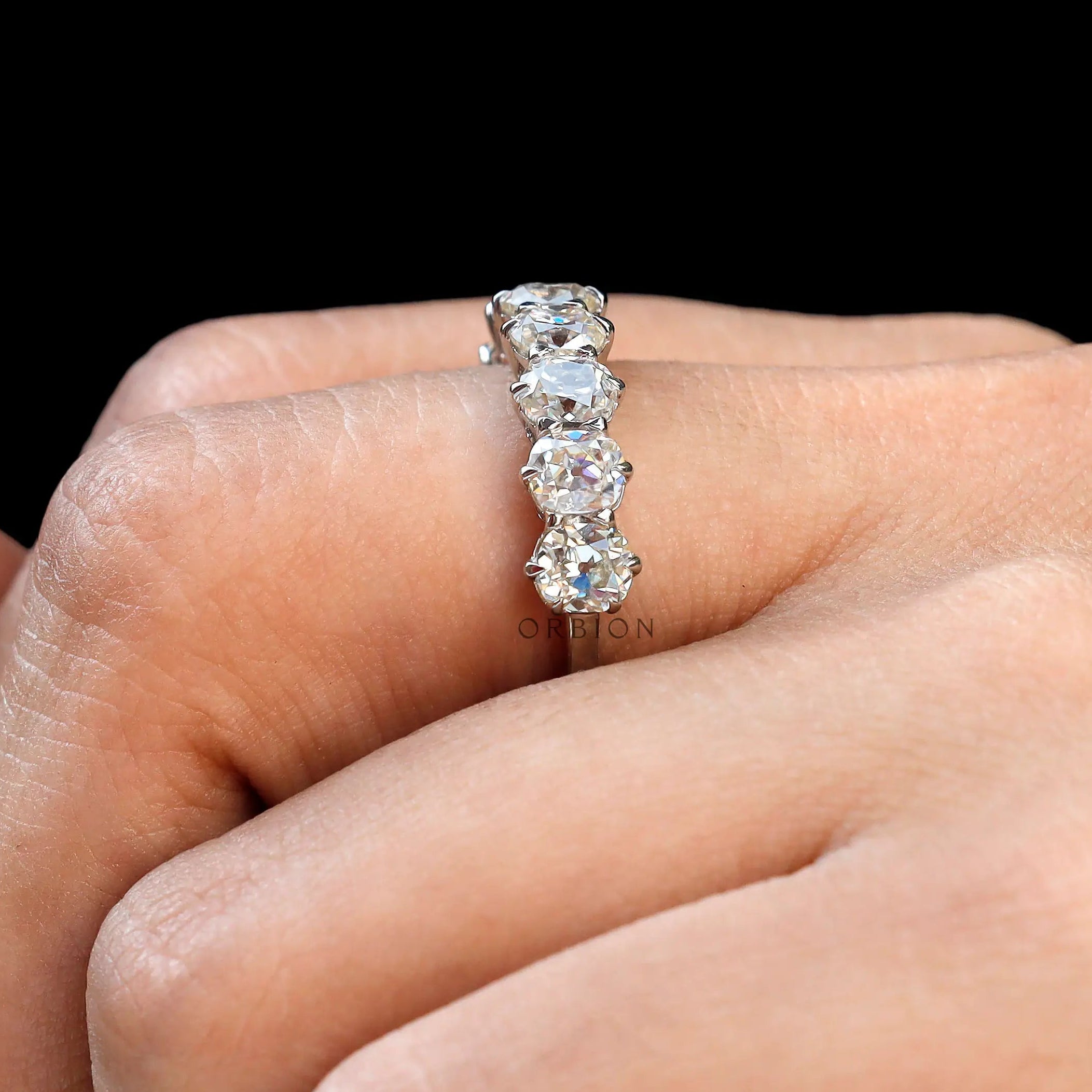Cushion cut old mine moissanite wedding band on fingure