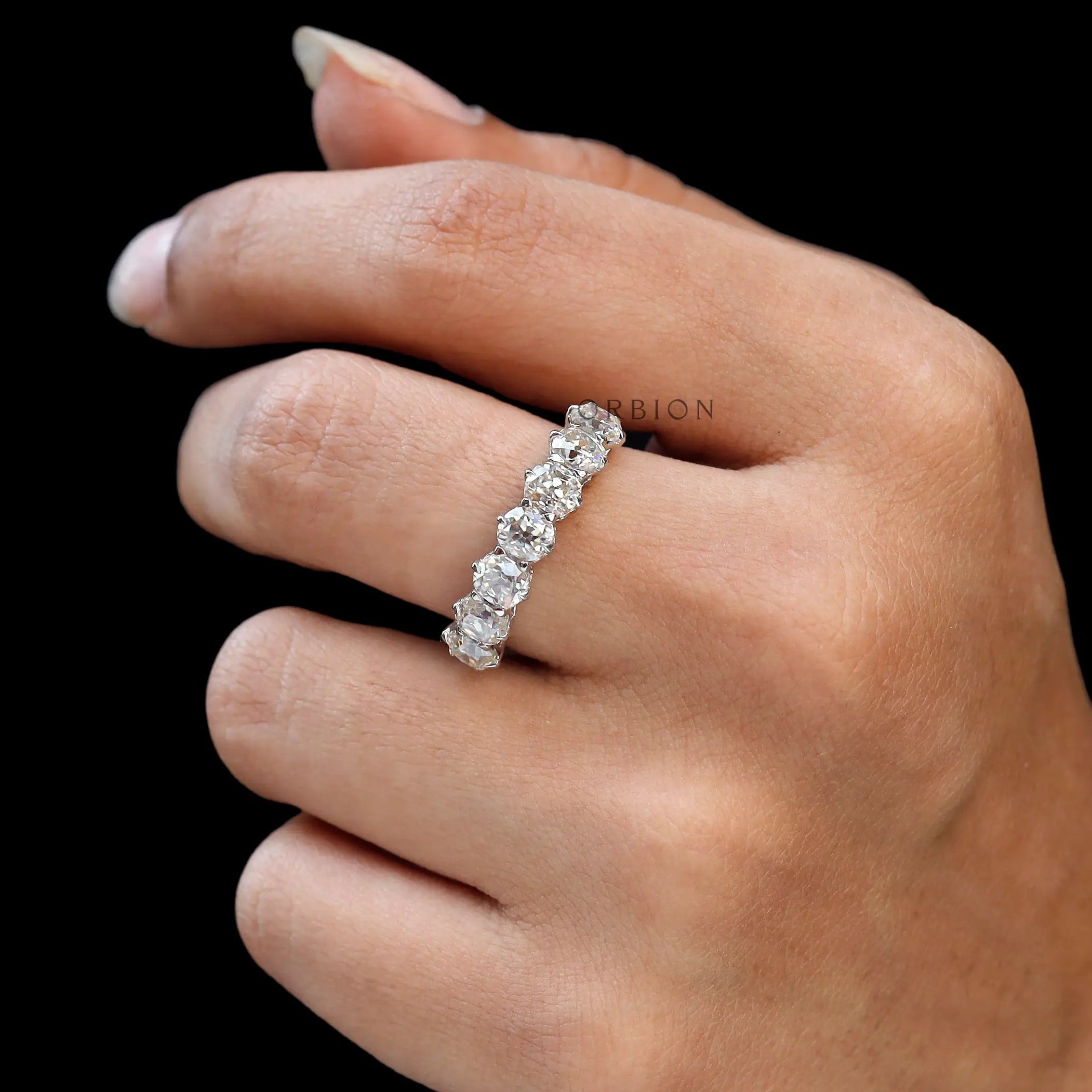 White gold old mine cut cushion moissanite ring on finger