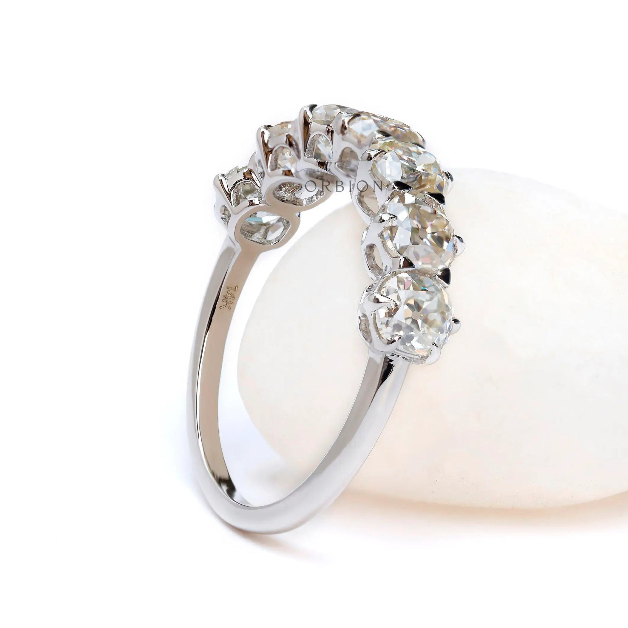 Seven stone moissanite band with glossy white gold finish