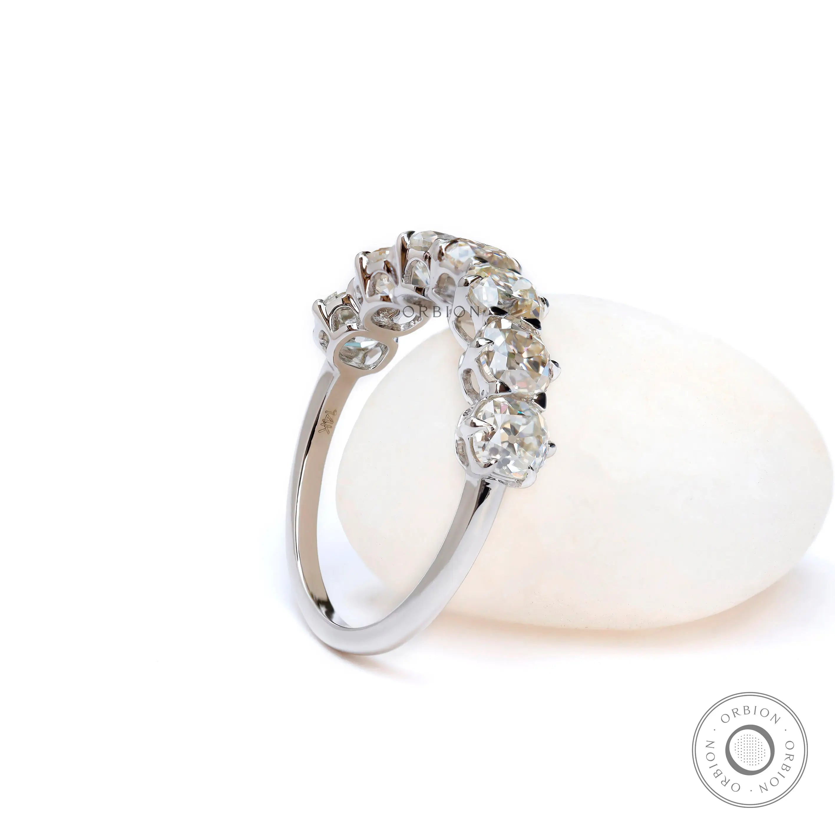 Seven stone moissanite band with glossy white gold finish