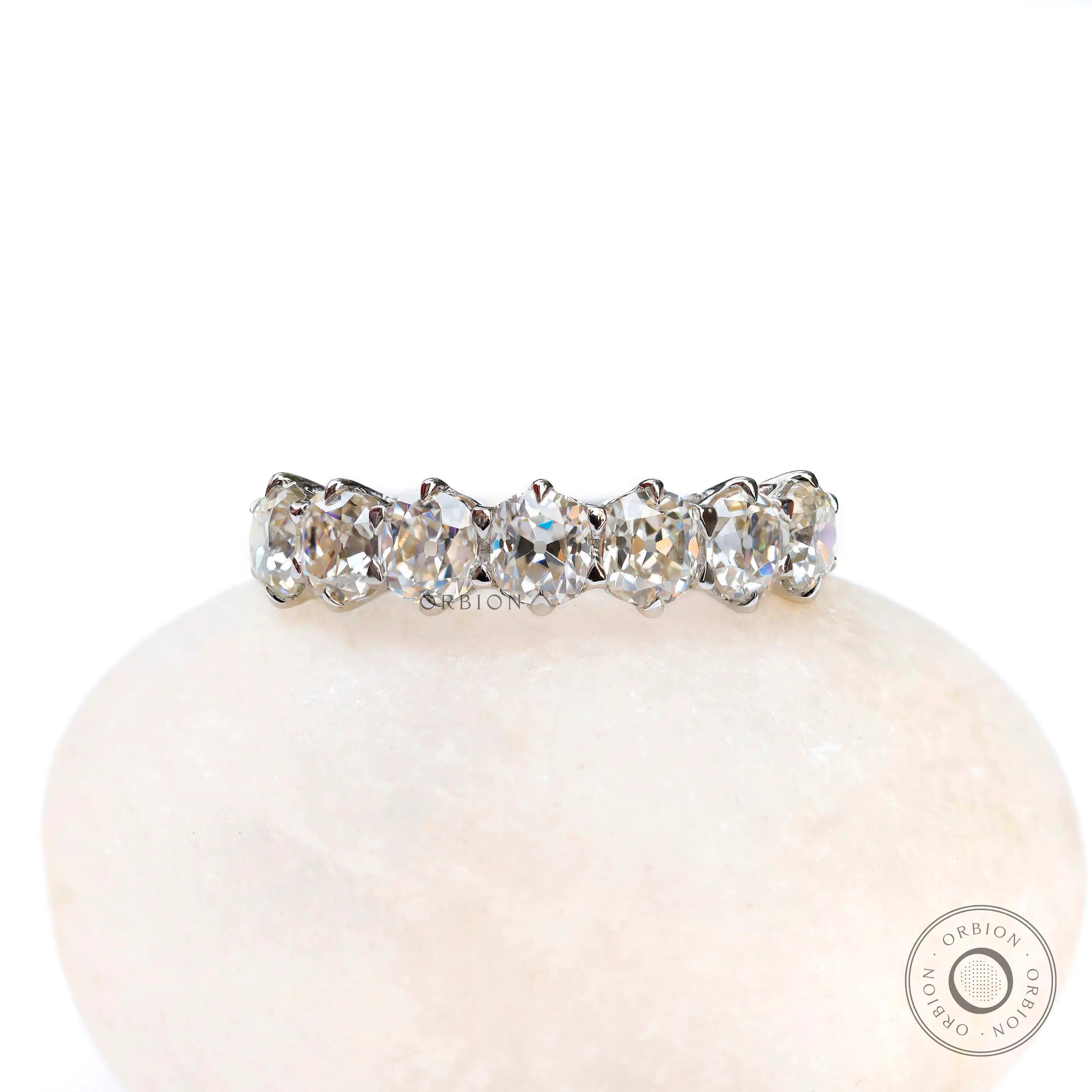 Seven stone old mine cut cushion moissanite wedding band in white gold