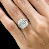 Platinum emerald cut trilogy engagement ring with trapezoid side stones