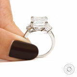 Platinum emerald cut engagement ring with trapezoid side diamonds