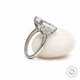 Side profile emerald cut three stone platinum ring