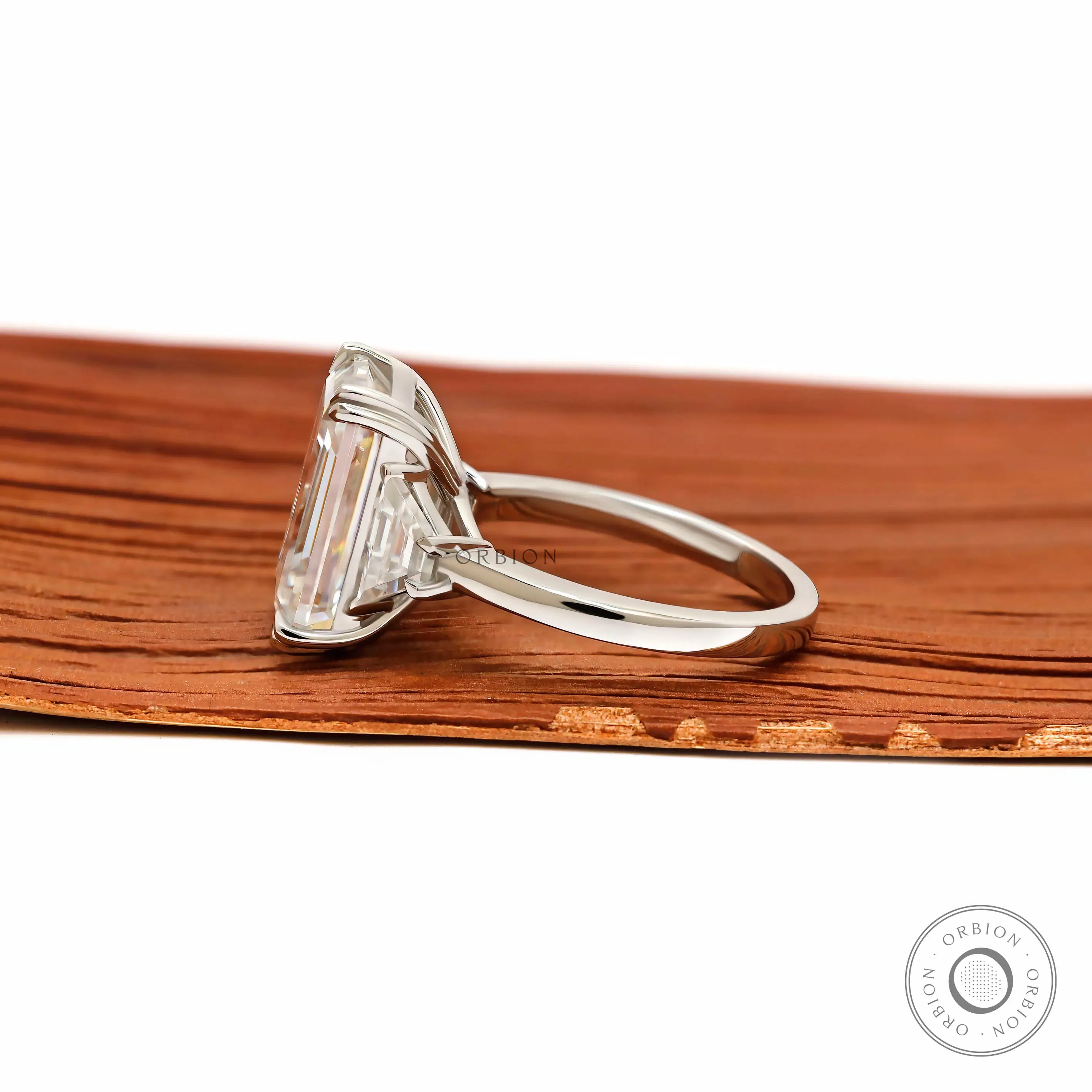 Elegant emerald cut platinum engagement ring with trapezoid accents