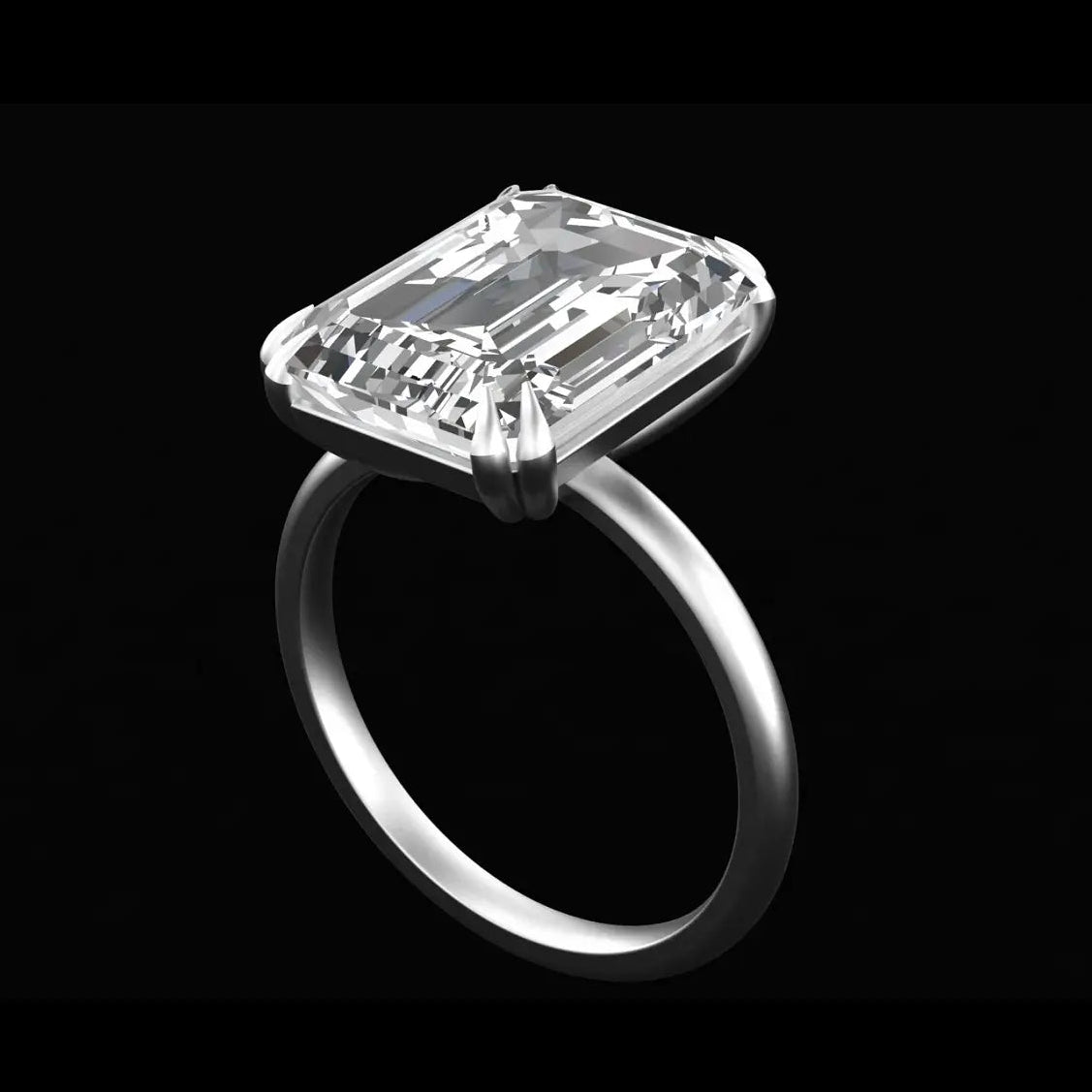 Emerald cut moissanite solitaire ring with double claw prongs