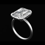 Emerald cut moissanite solitaire ring with double claw prongs