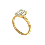 Angled View of krupp emerald cut moissanite on slim yellow gold band.