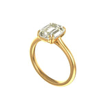 Angled View of krupp emerald cut moissanite on slim yellow gold band.