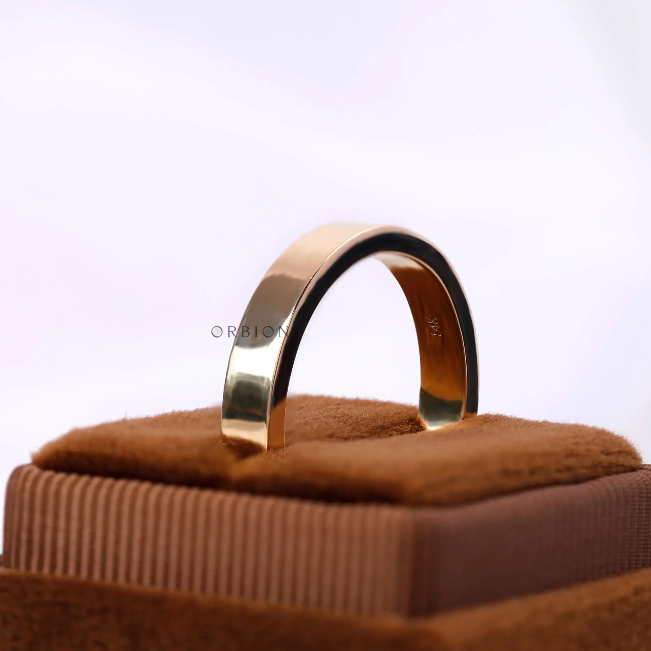Angled view flat gold comfort fit ring