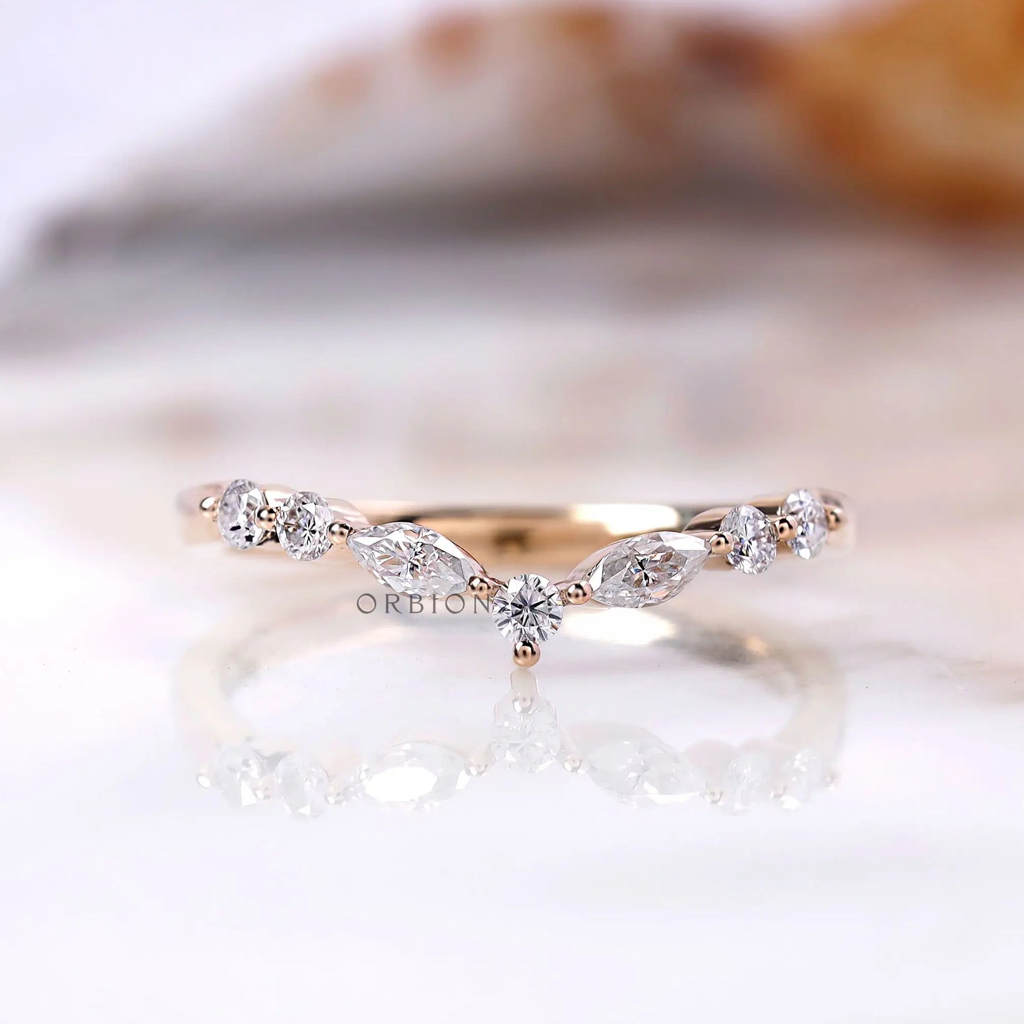 V-shaped chevron band with marquise and round moissanite accents