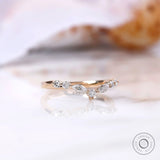 Angled view of marquise and round moissanite chevron ring