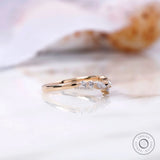Side profile showing prong-set marquise and round stones