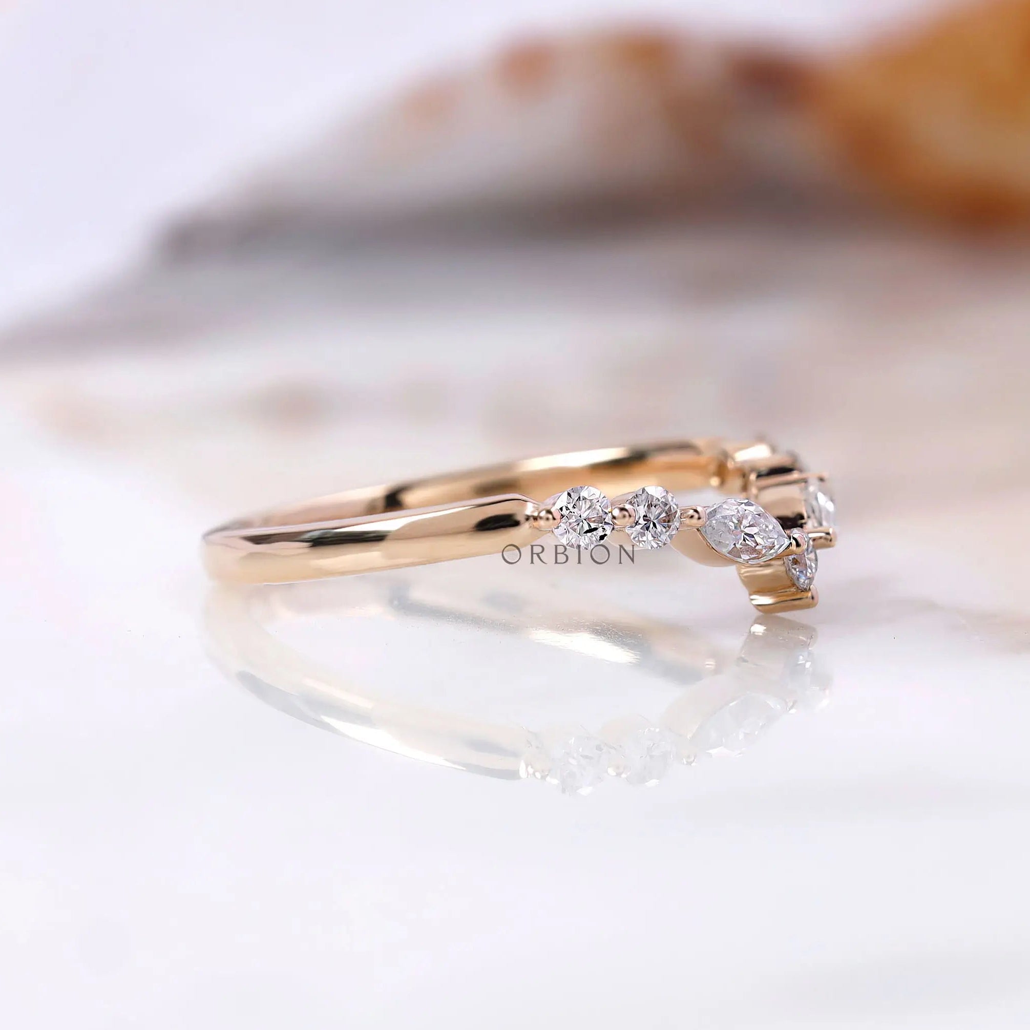 Side profile showing prong-set marquise and round stones