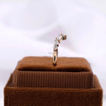 Upright view on ring box, chevron moissanite band