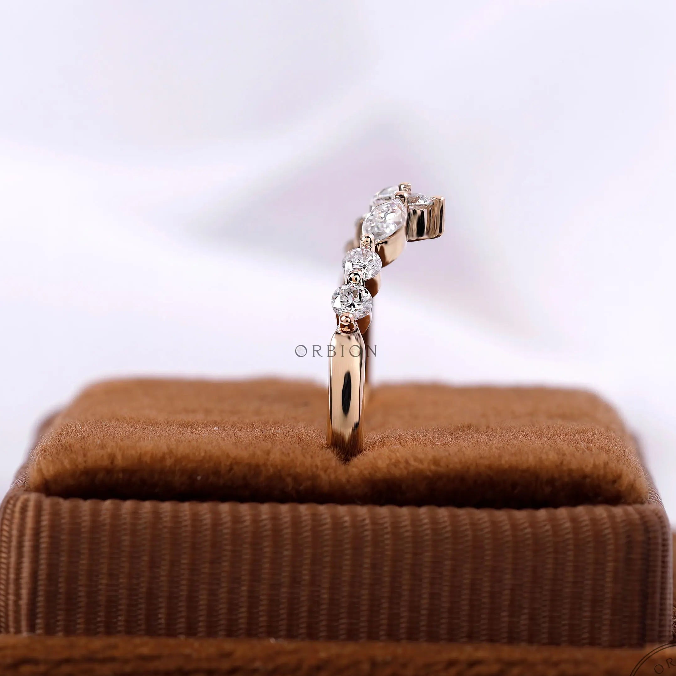 Upright view on ring box, chevron moissanite band