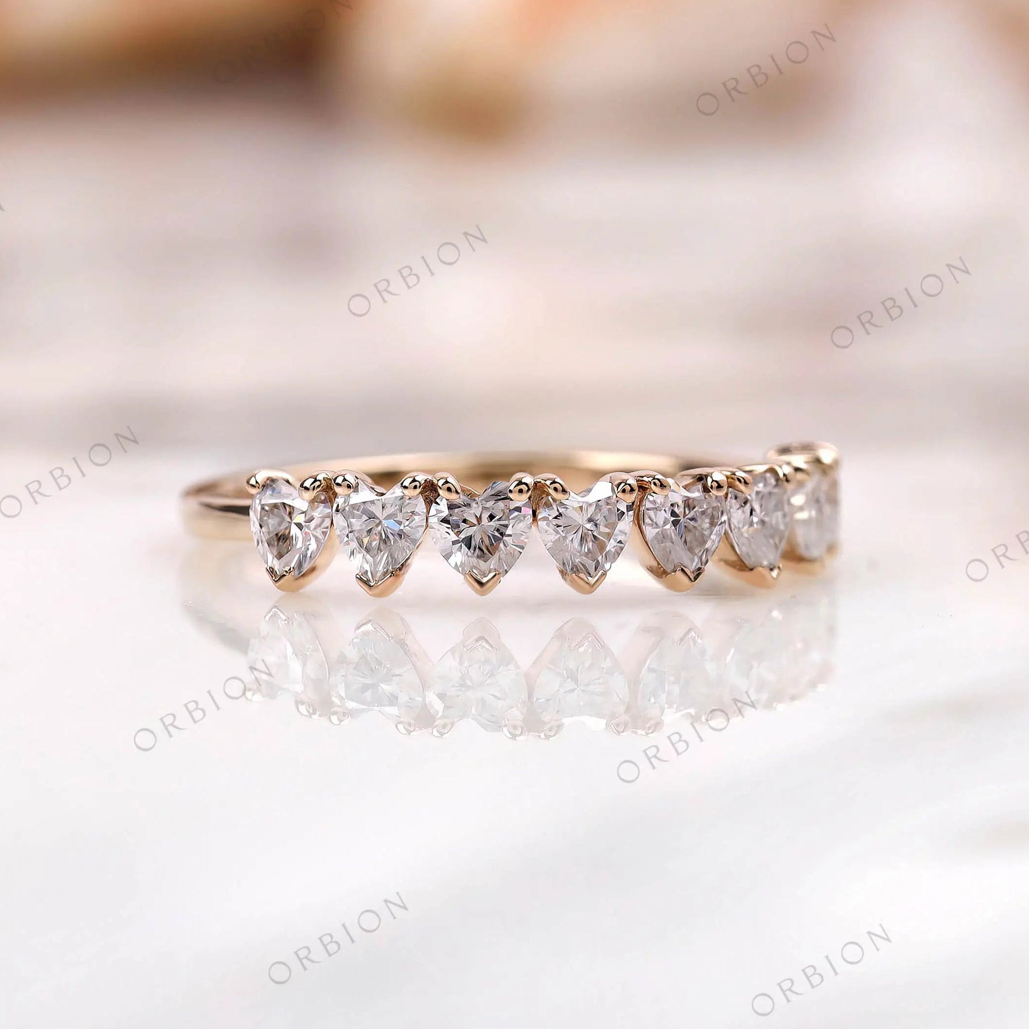 Heart half eternity wedding band, angled side view in yellow gold