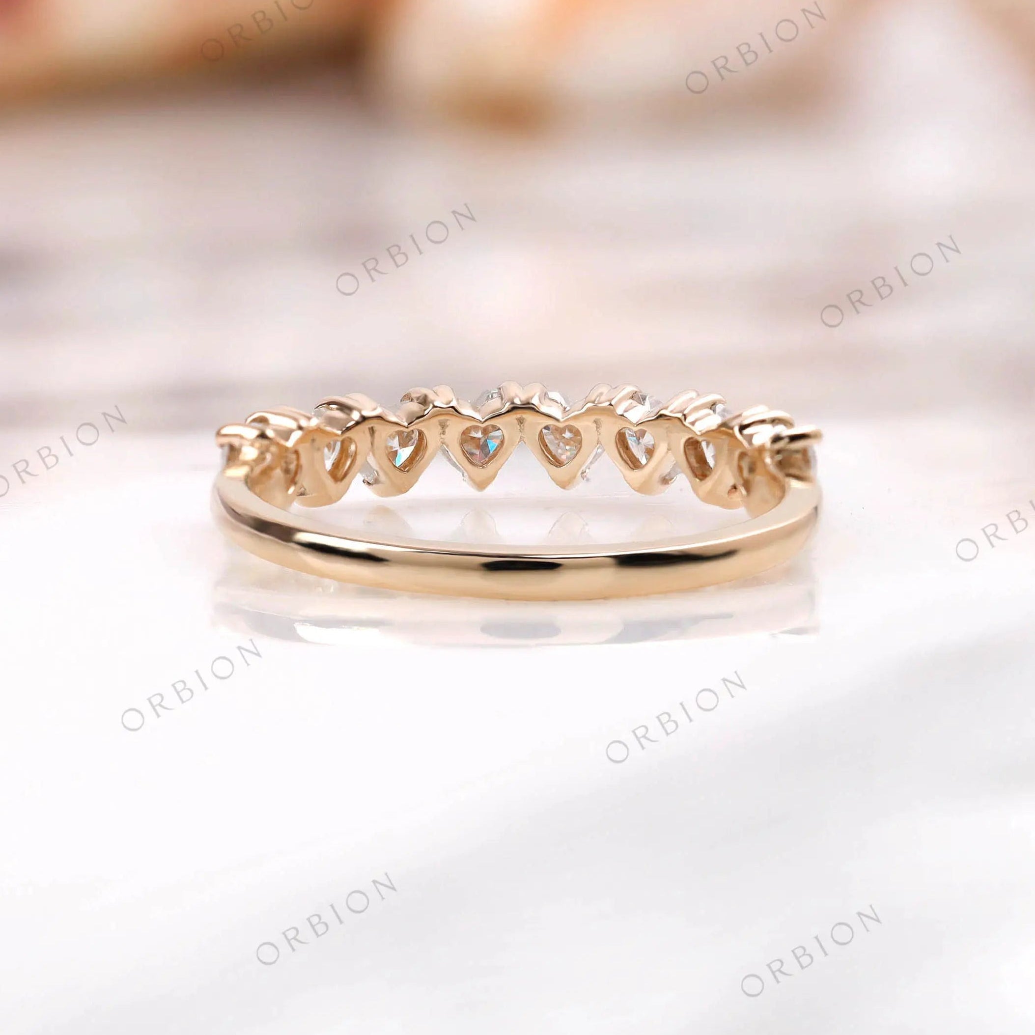 Heart motif gallery on heart shape half eternity band, rear view in yellow gold