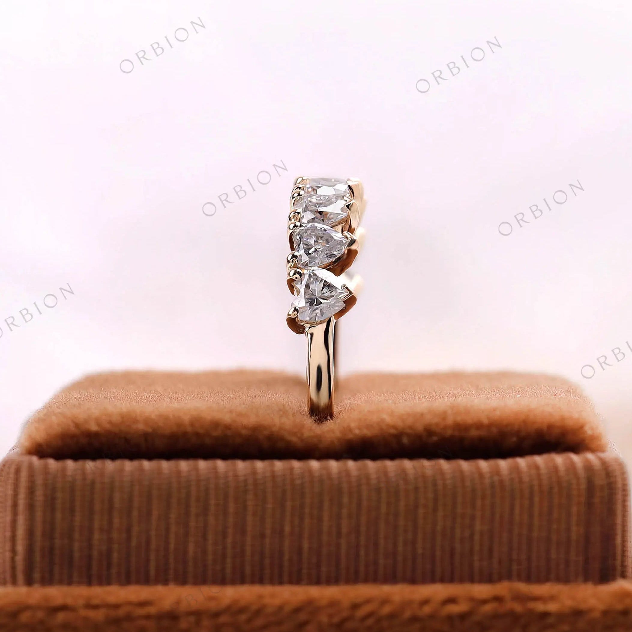 Heart half eternity ring, end view showing stone height and setting in yellow gold