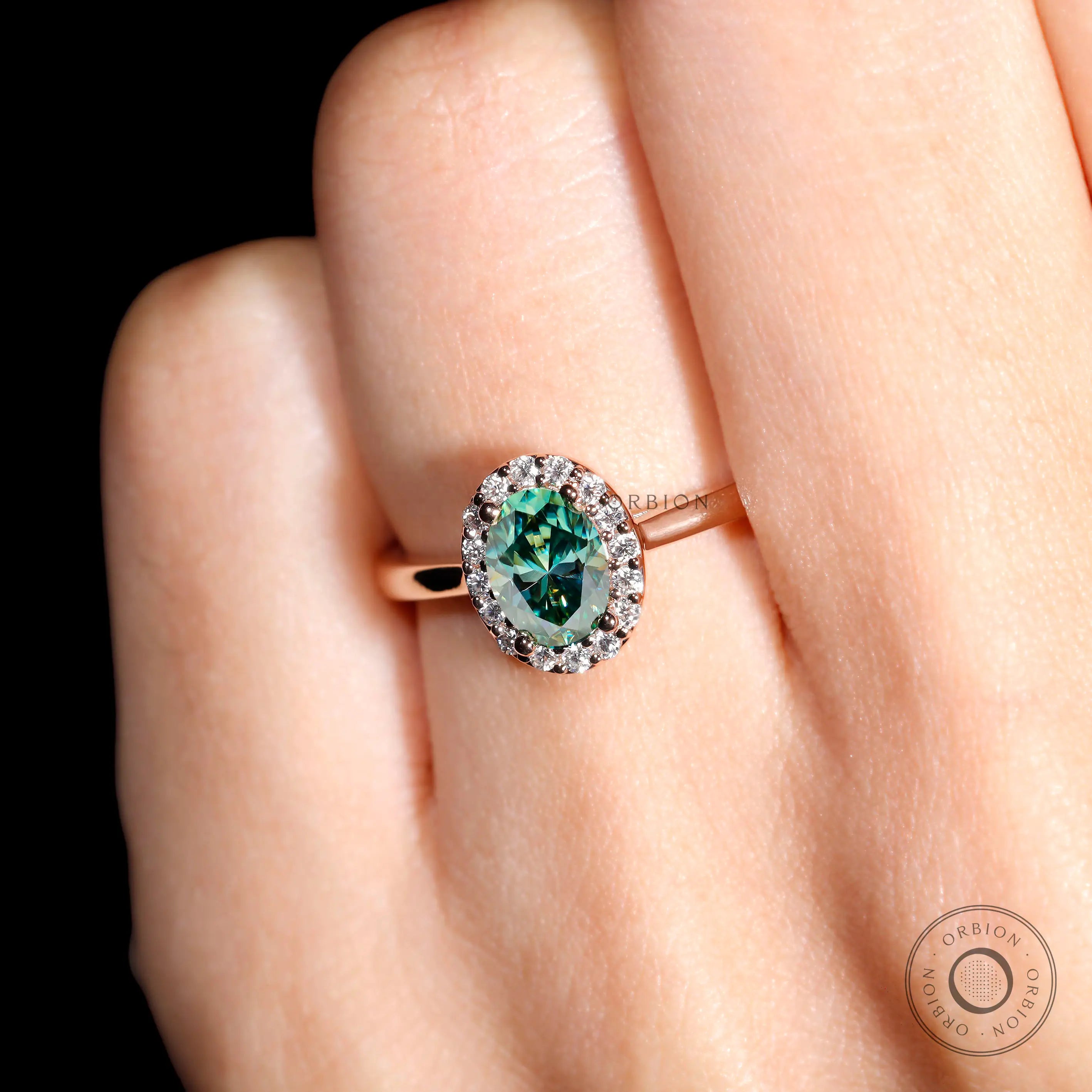Rose gold oval moissanite engagement ring studio view