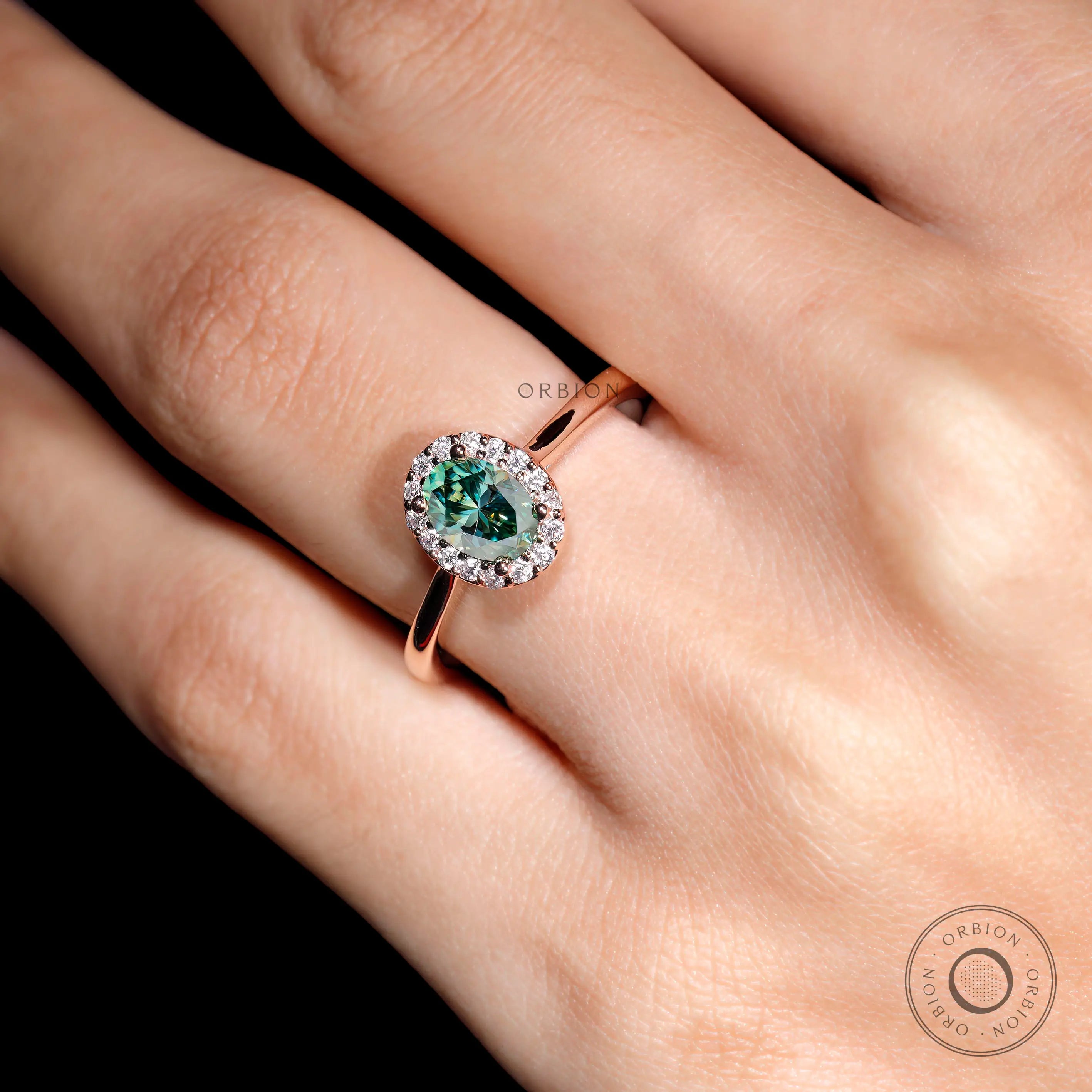 Elegant oval blue green moissanite ring close up