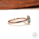 Oval blue green moissanite ring with round halo stones side view