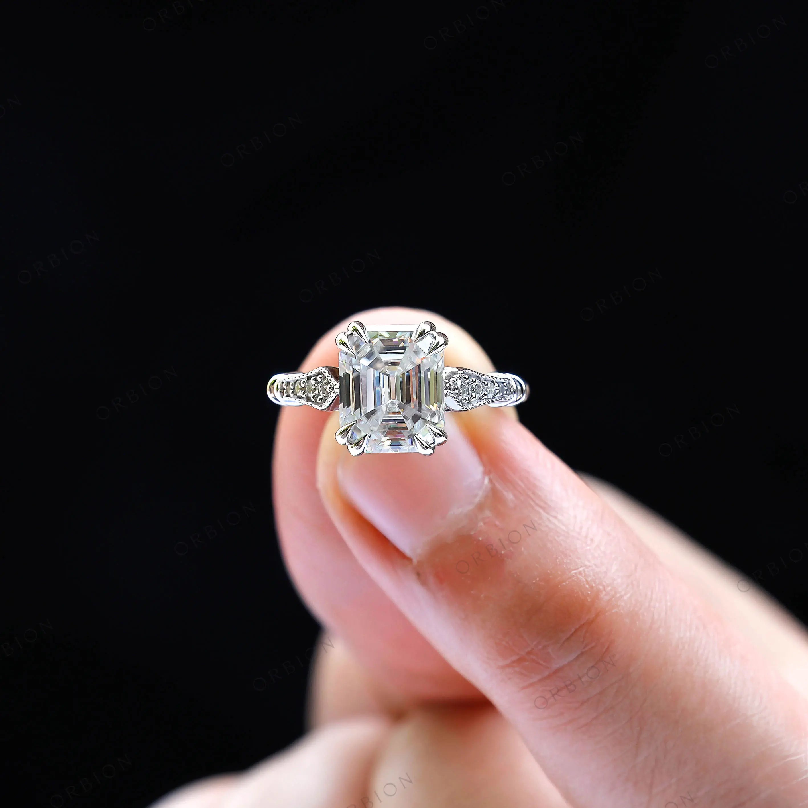 On hand view emerald cut moissanite solitaire ring
