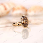 Oval dark champagne moissanite engagement ring high polish yellow gold close up