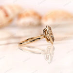 Side profile of bezel set oval moissanite ring in 14K yellow gold