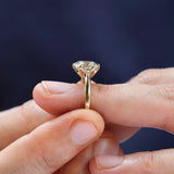 Elongated cushion moissanite solitaire ring worn on finger