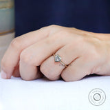 Heart shape solitaire ring in yellow gold on hand
