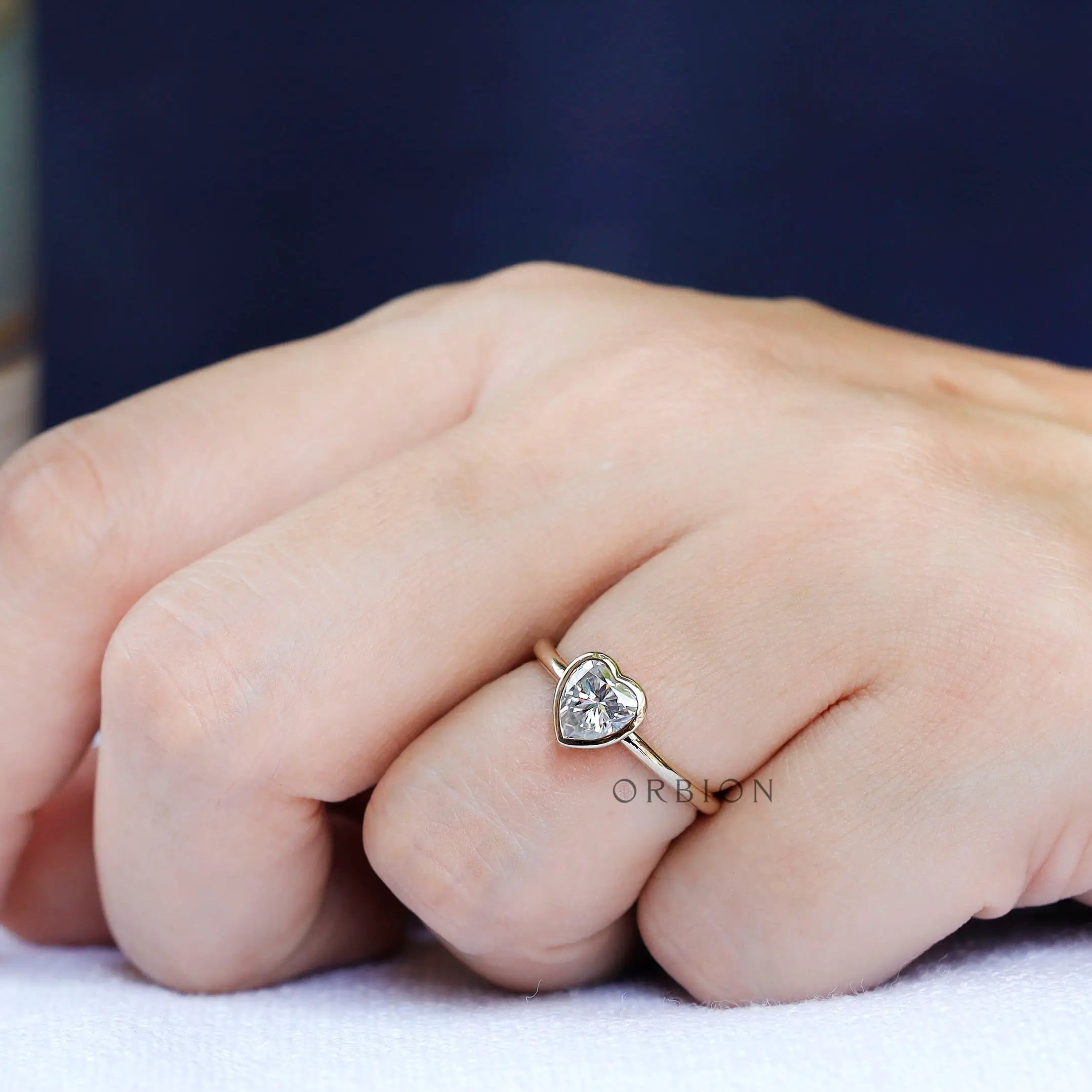 Heart shape solitaire ring in yellow gold on hand