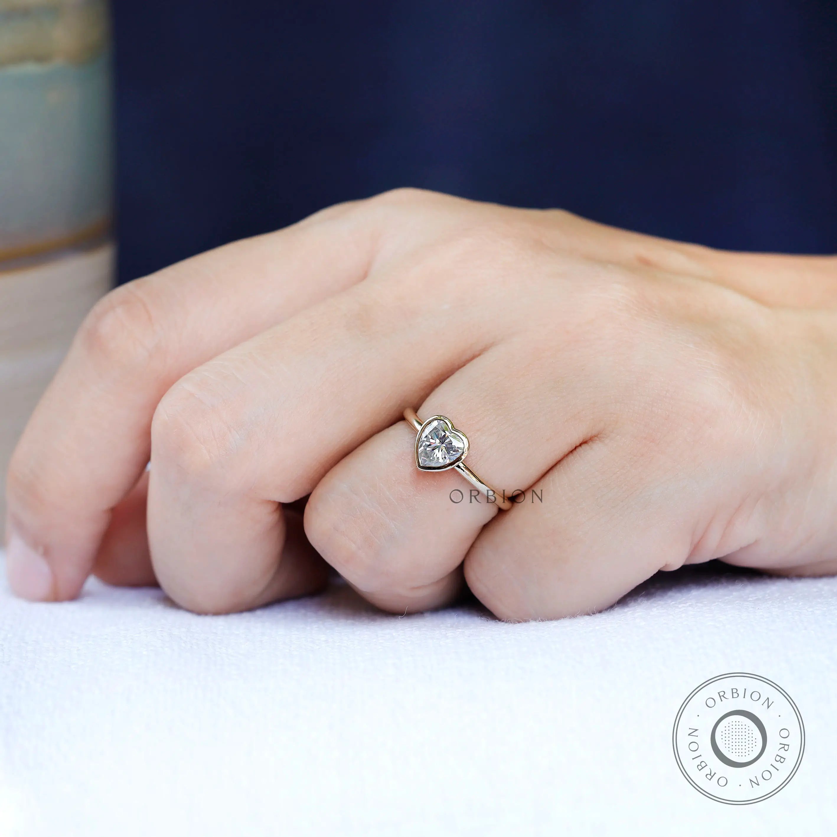 Heart shape solitaire ring in yellow gold on hand