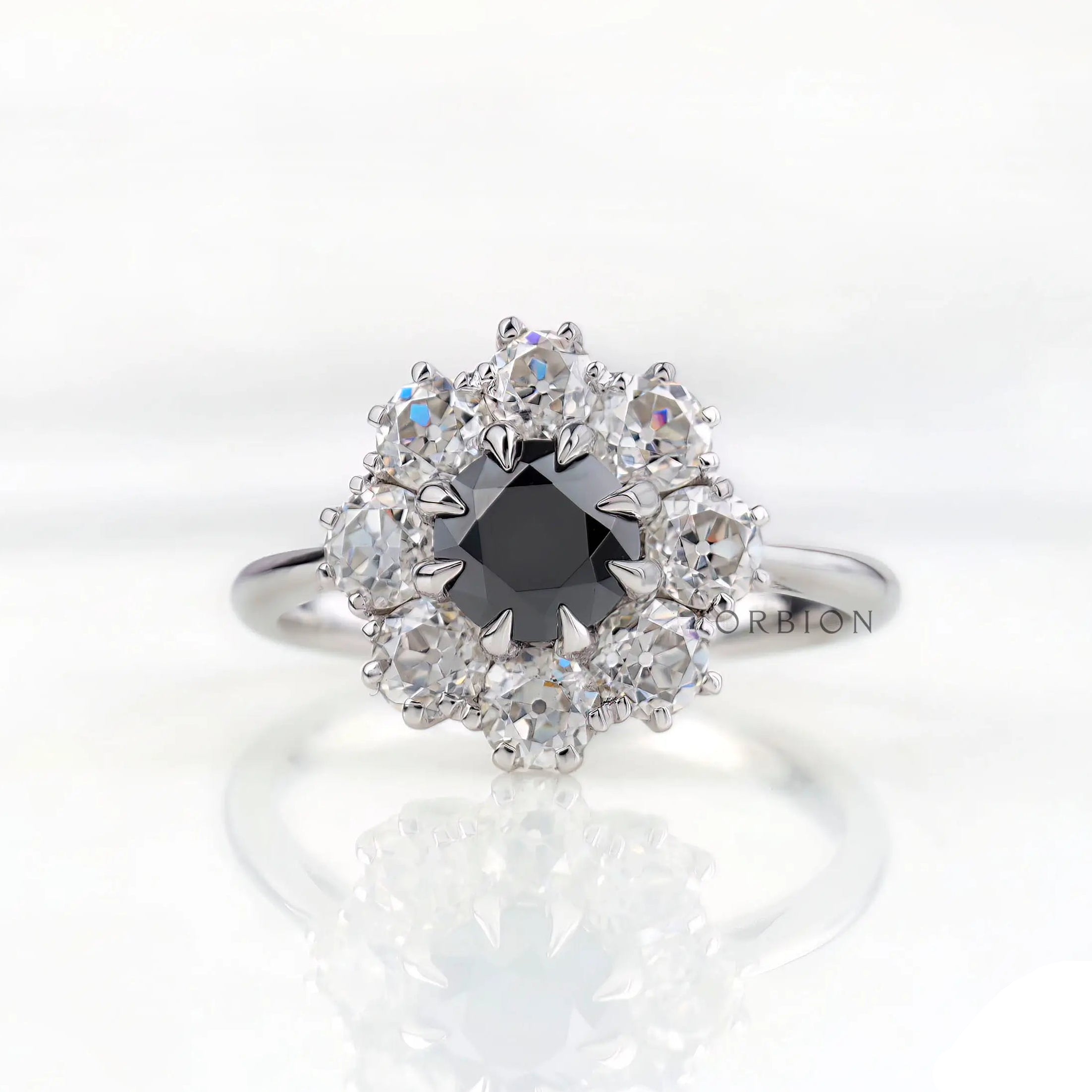 Front view vintage cluster halo ring with black moissanite center stone.