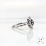 Side profile view highlighting raised halo head and slim white gold band.