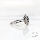 Side profile view highlighting raised halo head and slim white gold band.