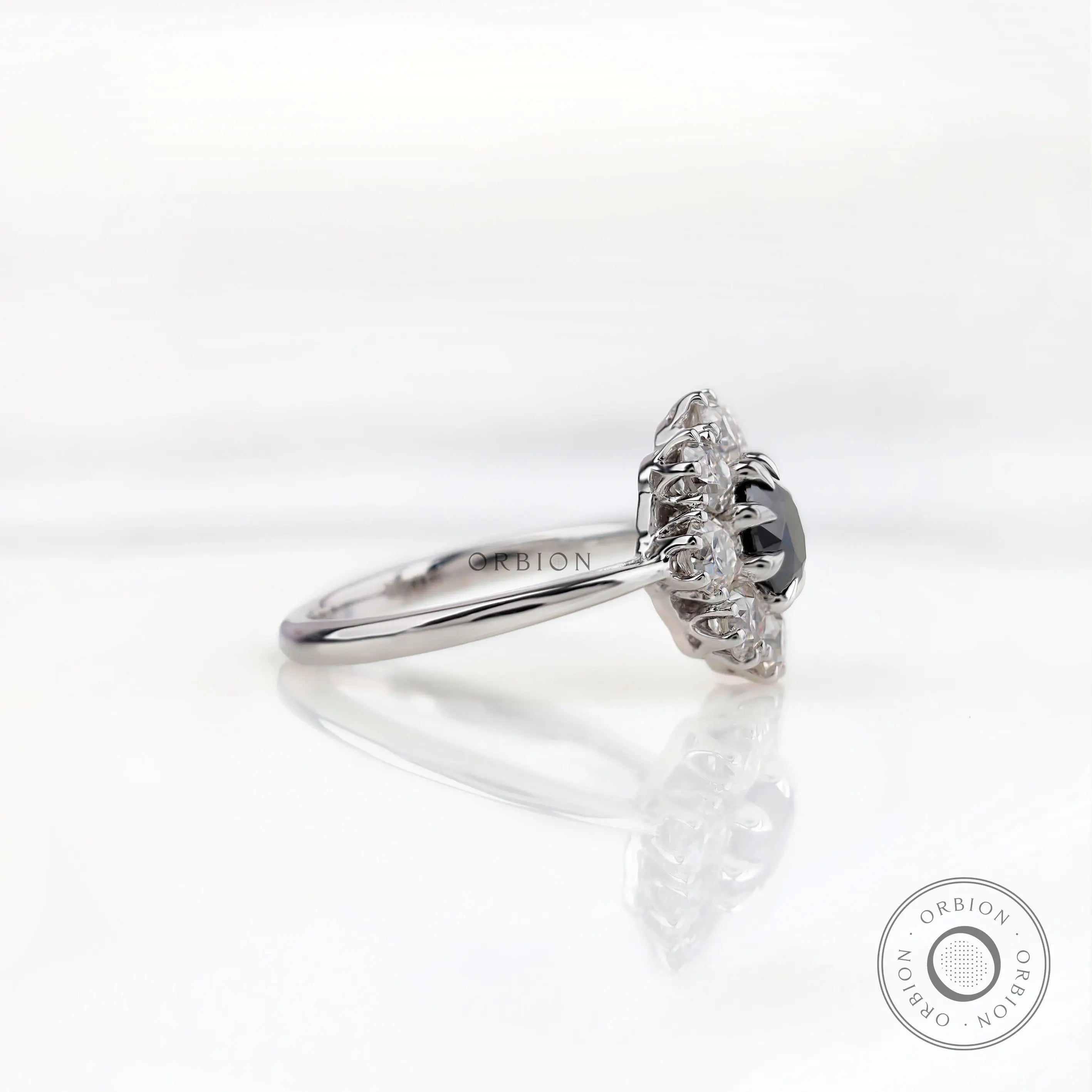 Side profile view highlighting raised halo head and slim white gold band.