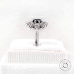 Rear side view on stand showing halo thickness and polished white gold shank.