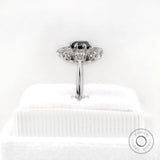 Rear side view on stand showing halo thickness and polished white gold shank.