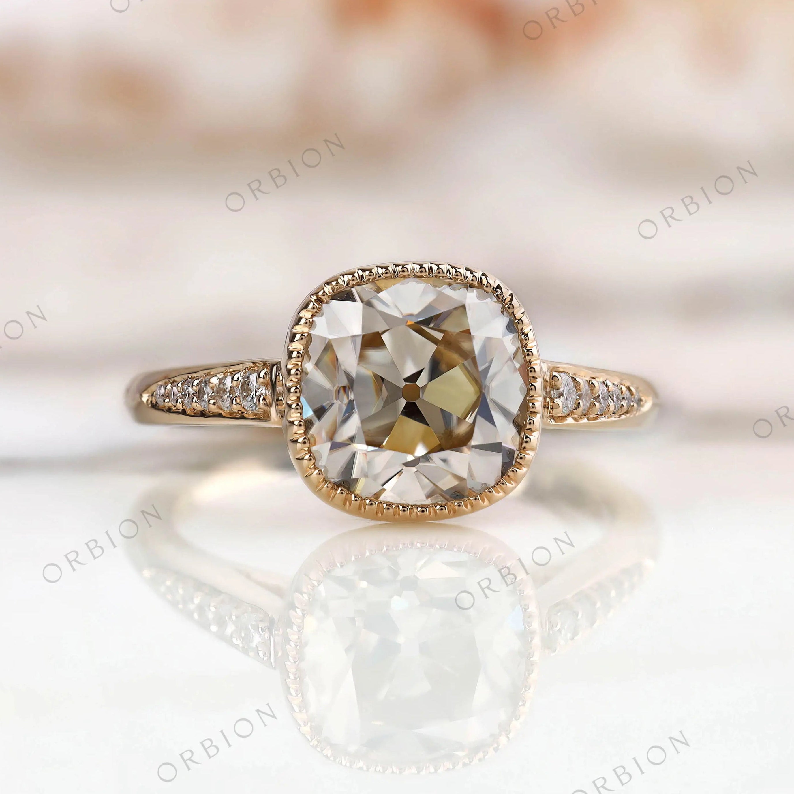 Bezel Set Cushion Cut Moissanite Engagement Ring with Round Side Stones in 14K Yellow Gold