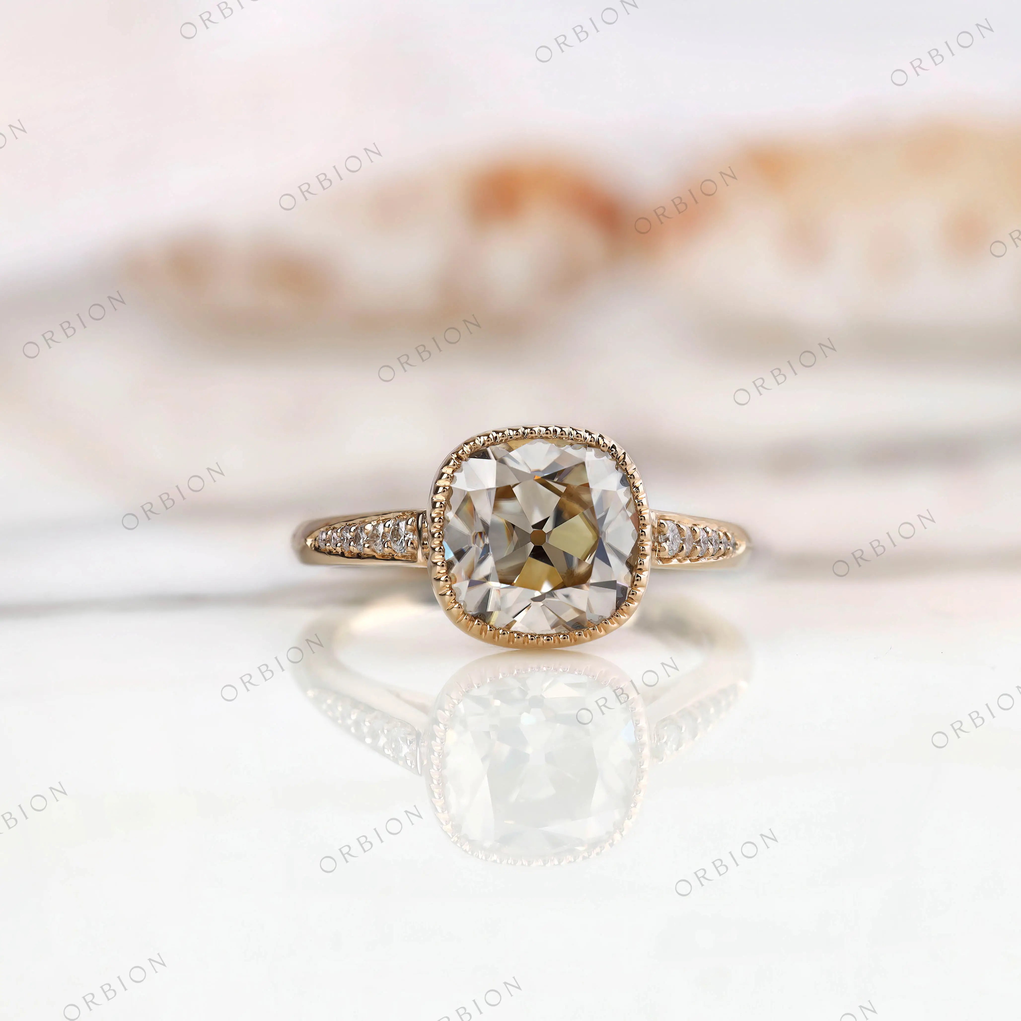 Bezel Set Cushion Cut Moissanite Engagement Ring with Round Side Stones in 14K Yellow Gold