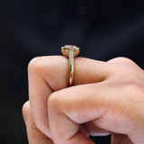 Hand model showcasing Bezel Set Cushion Cut Moissanite Engagement Ring in 14K Yellow Gold