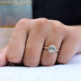Profile view of Bezel Set Cushion Cut Moissanite Engagement Ring on a finger with delicate side stone detailing