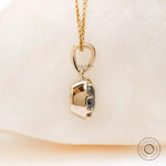 Angled view cushion moissanite pendant in yellow gold bezel